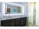 Modern bathroom with double vanity, large mirror, and walk-in shower at 475 Winwood Ct, Port Charlotte, FL 33954