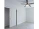 Bright bedroom with ceiling fan, tiled floor, and sliding closet door at 475 Winwood Ct, Port Charlotte, FL 33954