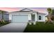 Charming one-story home with light gray garage door and landscaping at 475 Winwood Ct, Port Charlotte, FL 33954