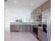 Modern kitchen with stainless steel appliances and gray cabinets at 475 Winwood Ct, Port Charlotte, FL 33954