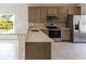 Modern kitchen with stainless steel appliances and gray cabinets at 475 Winwood Ct, Port Charlotte, FL 33954