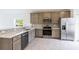 Modern kitchen with stainless steel appliances and gray cabinets at 475 Winwood Ct, Port Charlotte, FL 33954