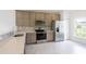 Modern kitchen with stainless steel appliances and gray cabinets at 475 Winwood Ct, Port Charlotte, FL 33954