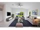 Spacious living room with comfortable sofas and large window at 475 Winwood Ct, Port Charlotte, FL 33954