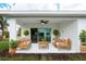 Relaxing patio with wooden furniture and lush landscaping at 475 Winwood Ct, Port Charlotte, FL 33954