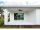 Covered patio with sliding glass doors and ceiling fan at 475 Winwood Ct, Port Charlotte, FL 33954