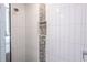 Shower with pebble stone accent and modern white tile at 475 Winwood Ct, Port Charlotte, FL 33954