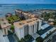 Aerial view of waterfront condo building with parking and marina at 622 Edgewater Dr # 523, Dunedin, FL 34698