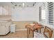 Bright breakfast nook with wood table and chairs at 622 Edgewater Dr # 523, Dunedin, FL 34698