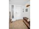 Condo entryway with tiled floor, storage bench, and coastal decor at 622 Edgewater Dr # 523, Dunedin, FL 34698