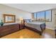 Bedroom featuring wood floors, dresser and a large window with a city view at 6287 Bahia Del Mar Cir # 603, St Petersburg, FL 33715