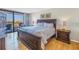 The main bedroom features a king bed, balcony and wood floors at 6287 Bahia Del Mar Cir # 603, St Petersburg, FL 33715