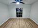 Well-lit bedroom featuring light wood laminate flooring and a large window at 7007 Oakview Cir, Tampa, FL 33634