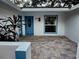 Front entry with blue door and newly paved patio at 7007 Oakview Cir, Tampa, FL 33634