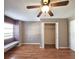 Bright bedroom with wood floors, a ceiling fan, and a spacious closet at 7805 Pine Trace Dr, Sarasota, FL 34243