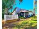 White deck with wooden steps and surrounding greenery at 7805 Pine Trace Dr, Sarasota, FL 34243