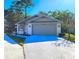 Single-story home with attached garage and landscaping at 7805 Pine Trace Dr, Sarasota, FL 34243