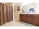 Bathroom with a double vanity, shower, and tile floor at 8423 Blue Rock Dr, New Port Richey, FL 34653