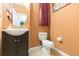 Clean and updated half bathroom with a dark vanity and tile floor at 8423 Blue Rock Dr, New Port Richey, FL 34653
