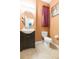 Clean and updated half bathroom with a dark vanity and tile floor at 8423 Blue Rock Dr, New Port Richey, FL 34653