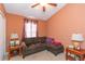 Bedroom with L-shaped sofa, side tables, and window at 8423 Blue Rock Dr, New Port Richey, FL 34653
