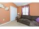 Bedroom with L-shaped sofa, side tables, and window at 8423 Blue Rock Dr, New Port Richey, FL 34653