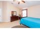 Well-lit bedroom with a full bed and dresser at 8423 Blue Rock Dr, New Port Richey, FL 34653