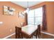 Charming dining area with wood table and chairs, and a lovely chandelier at 8423 Blue Rock Dr, New Port Richey, FL 34653