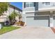 View of a three-car garage and landscaping at 8423 Blue Rock Dr, New Port Richey, FL 34653