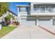 View of a three-car garage and walkway at 8423 Blue Rock Dr, New Port Richey, FL 34653
