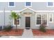 Dark brown front door with landscaping at 8423 Blue Rock Dr, New Port Richey, FL 34653