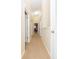 Long hallway with carpeted floor and access to bedrooms at 8423 Blue Rock Dr, New Port Richey, FL 34653