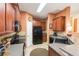 Modern kitchen with dark wood cabinets, black appliances, and ample counter space at 8423 Blue Rock Dr, New Port Richey, FL 34653