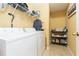 Convenient laundry room with washer, dryer, and shelving for storage at 8423 Blue Rock Dr, New Port Richey, FL 34653
