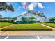 Community center with flag and landscaping at 844 Skyloch S Dr, Dunedin, FL 34698