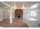 Living room with a wood paneled fireplace and wood flooring at 9541 Round Lake Dr, Weeki Wachee, FL 34613