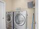 Laundry room with washer and dryer, shelving and broom at 1012 Tuscanny St, Brandon, FL 33511