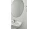 Elegant bathroom sink features a modern chrome faucet and oval mirror at 10320 Cross River Trl, Parrish, FL 34219