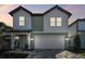 Two-story home with neutral exterior, large garage, and brick paver driveway at 10320 Cross River Trl, Parrish, FL 34219