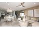 Open-concept living and dining area with modern furniture and neutral tones at 10320 Cross River Trl, Parrish, FL 34219