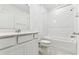 Modern bathroom with shower over tub, tiled walls, and a single sink vanity at 10328 Cross River Trl, Parrish, FL 34219