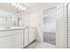 Bathroom with double sink vanity and a glimpse into the bedroom at 10328 Cross River Trl, Parrish, FL 34219