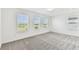 Bright bedroom with multiple windows and neutral carpeting at 10328 Cross River Trl, Parrish, FL 34219