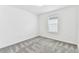 This room has white walls, a window, baseboards and trim, plus neutral carpet and a ceiling light at 10328 Cross River Trl, Parrish, FL 34219