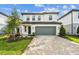 Charming two-story home featuring a paved driveway, attached two-car garage, and well-manicured landscaping at 10328 Cross River Trl, Parrish, FL 34219