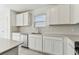 Well-lit kitchen featuring white cabinets, subway tile backsplash and stainless steel sink at 10328 Cross River Trl, Parrish, FL 34219