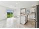 Open kitchen featuring a large island, white cabinets, and stainless steel appliances at 10328 Cross River Trl, Parrish, FL 34219