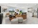 Bright living room featuring contemporary furniture and open layout with access to kitchen at 10328 Cross River Trl, Parrish, FL 34219