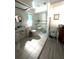 Accessible bathroom with roll-in shower, toilet, and modern vanity at 11253 Leland St, Spring Hill, FL 34609