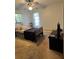 Bedroom with ceiling fan, hospital bed, and ample closet space at 11253 Leland St, Spring Hill, FL 34609